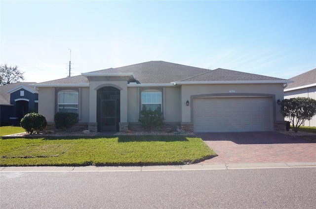 ranch-style home featuring a garage and a front yard