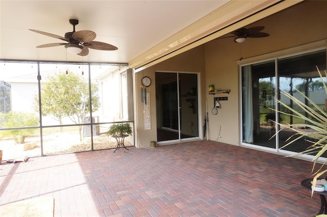 unfurnished sunroom with ceiling fan