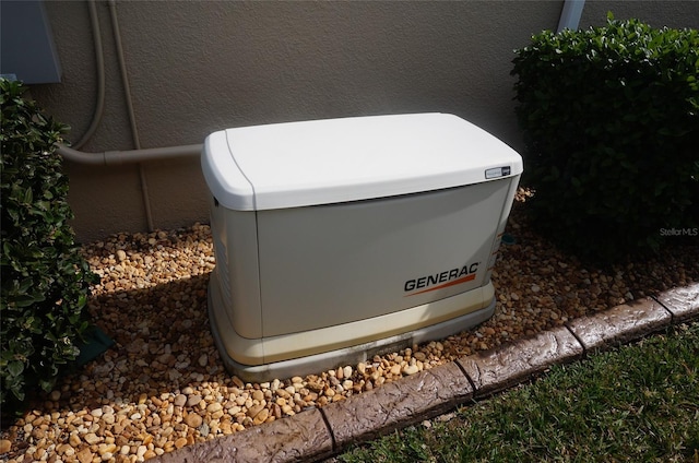 details featuring stucco siding and a power unit