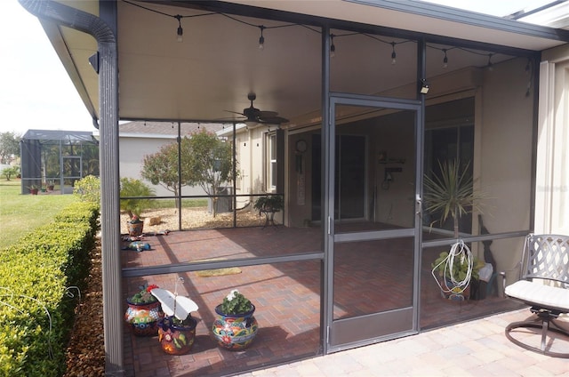 view of patio / terrace featuring glass enclosure and ceiling fan