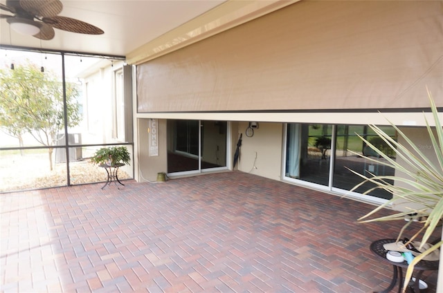 unfurnished sunroom with a ceiling fan