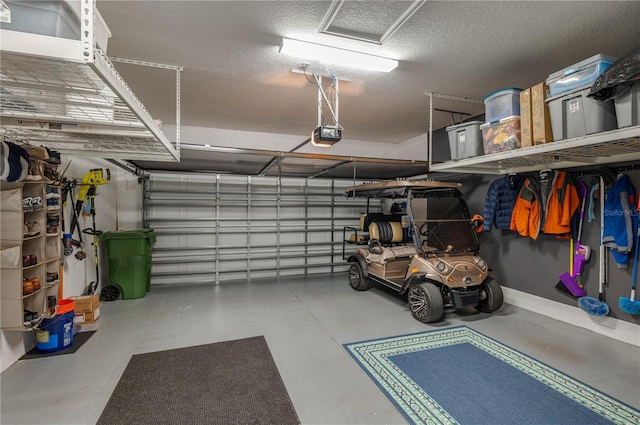 garage with baseboards and a garage door opener