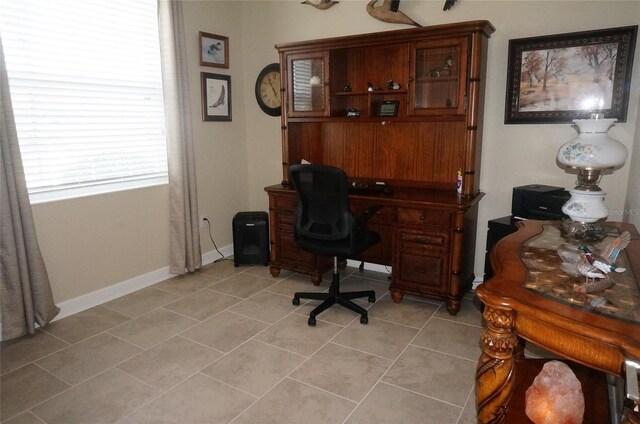 office area with baseboards and light tile patterned floors