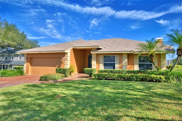 view of front of property with a garage and a front lawn