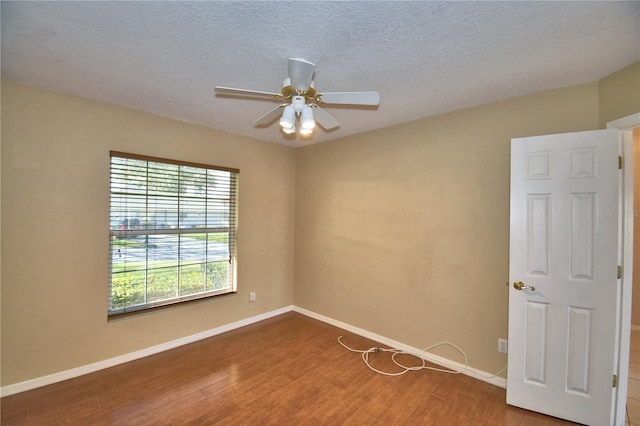 spare room with hardwood / wood-style flooring, a textured ceiling, and ceiling fan