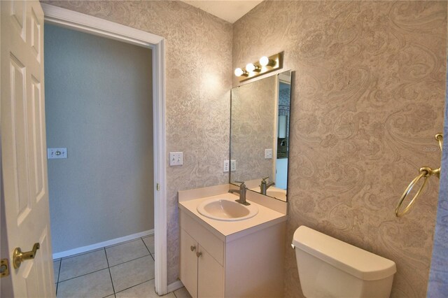 bathroom featuring tile patterned floors, toilet, and vanity