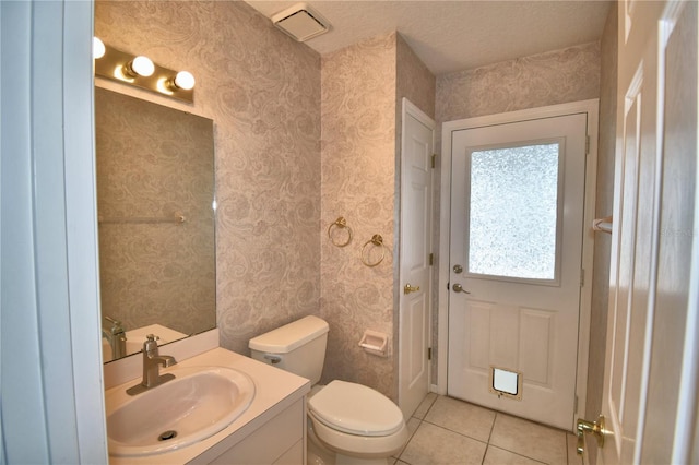 bathroom with tile patterned flooring, vanity, and toilet