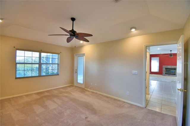 carpeted empty room with vaulted ceiling and ceiling fan