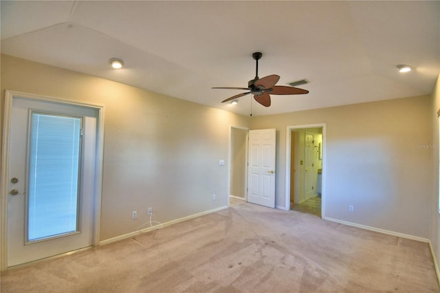 carpeted empty room featuring vaulted ceiling and ceiling fan