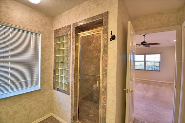 bathroom with walk in shower and ceiling fan