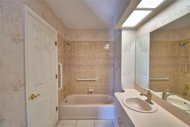 bathroom featuring vanity, tiled shower / bath combo, and tile patterned flooring