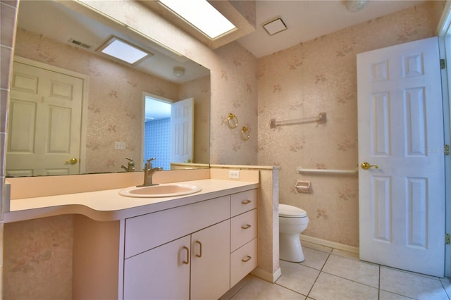 bathroom featuring tile patterned floors, toilet, and vanity