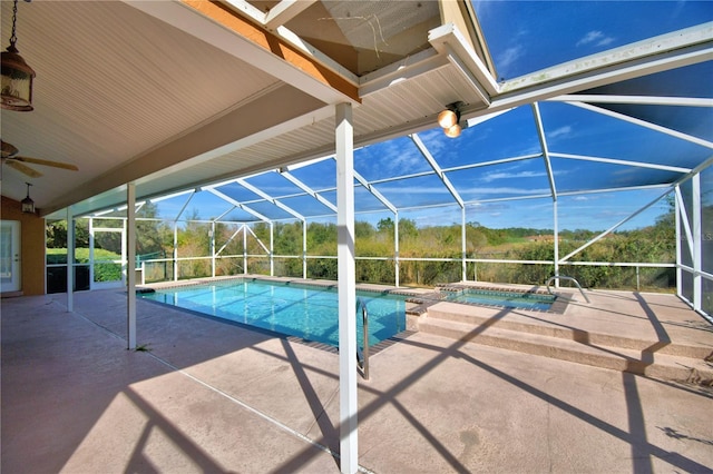 view of swimming pool featuring an in ground hot tub, a lanai, and a patio area