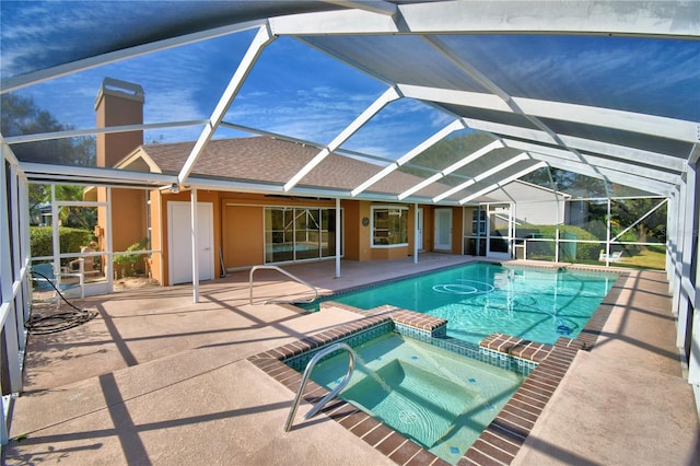 view of swimming pool featuring a lanai, a patio area, and an in ground hot tub