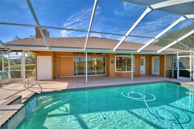 view of swimming pool featuring a patio and glass enclosure