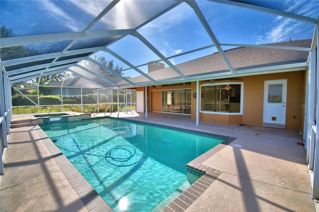 view of swimming pool featuring a patio, a lanai, and an in ground hot tub