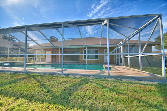 rear view of house featuring a yard, a lanai, and a patio area