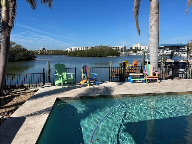 view of pool featuring a patio and a water view