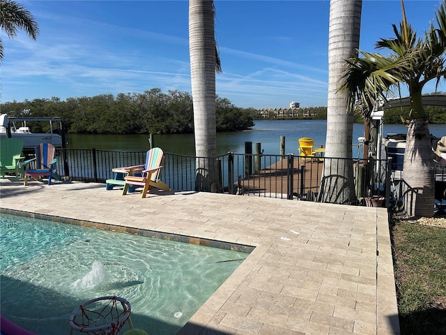 view of pool featuring a patio area and a water view