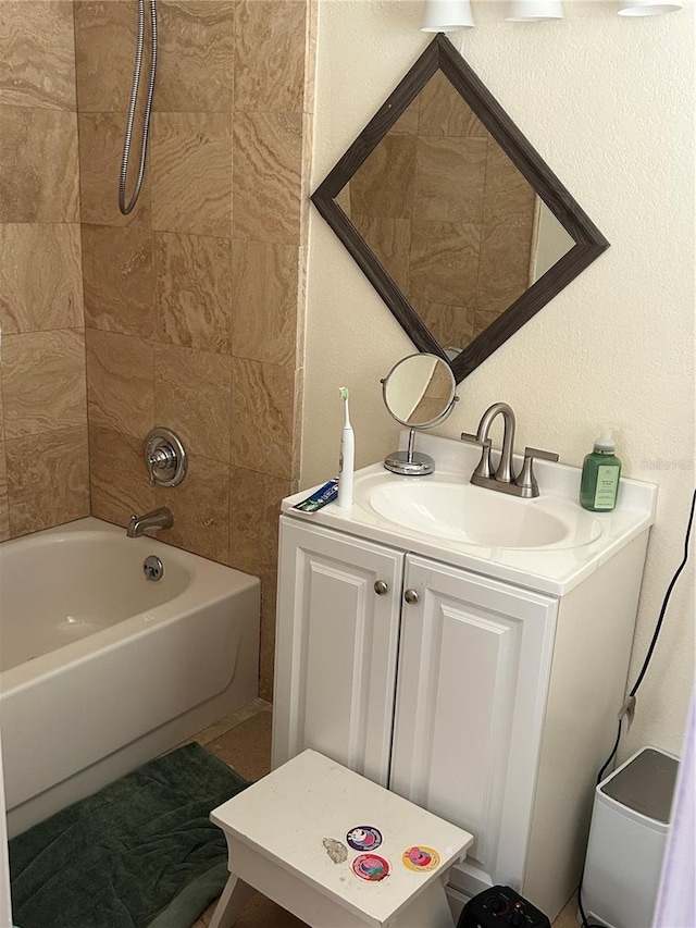 bathroom with vanity and tiled shower / bath combo