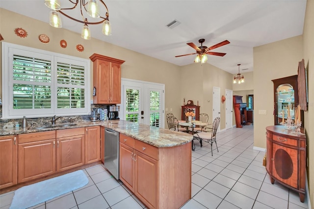 kitchen featuring light tile patterned flooring, sink, stainless steel dishwasher, pendant lighting, and light stone countertops