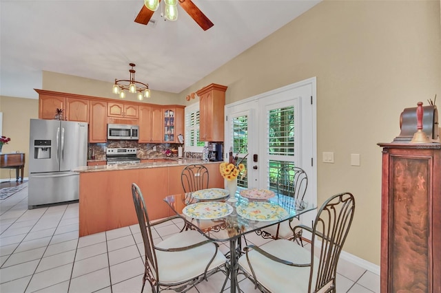 dining room with light tile patterned flooring, ceiling fan, and french doors