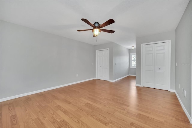 spare room with ceiling fan and light wood-type flooring