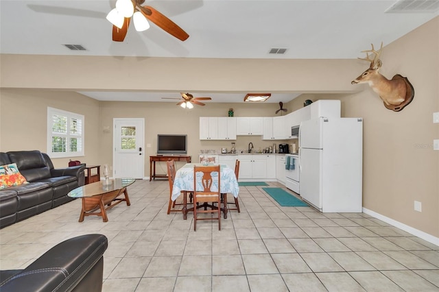 interior space with sink, ceiling fan, and light tile patterned flooring