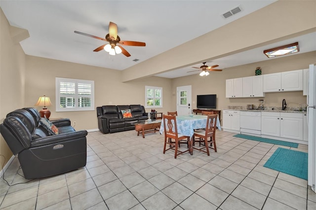 living room featuring ceiling fan and light tile patterned floors