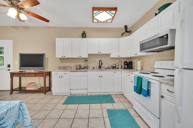 kitchen featuring sink, white appliances, white cabinets, and light tile patterned flooring