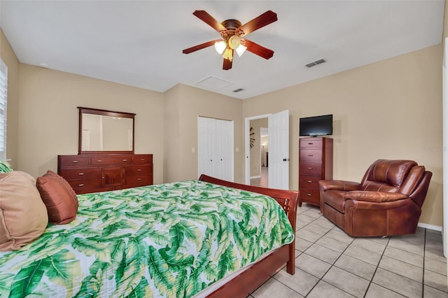 tiled bedroom featuring ceiling fan and a closet