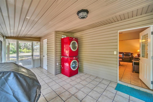 sunroom featuring wood ceiling and stacked washer / dryer