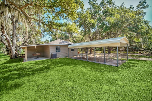 back of house with central AC and a lawn