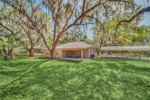 view of yard with cooling unit and a carport