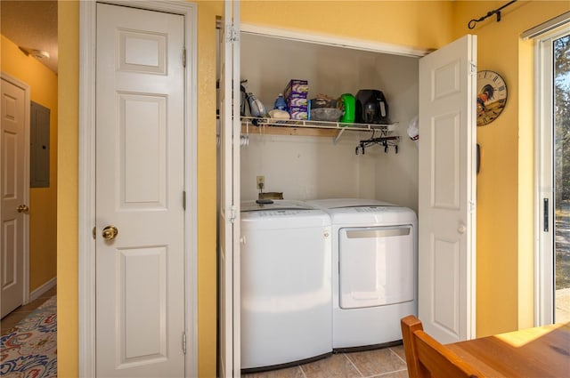 washroom with washing machine and clothes dryer, electric panel, and light tile patterned floors