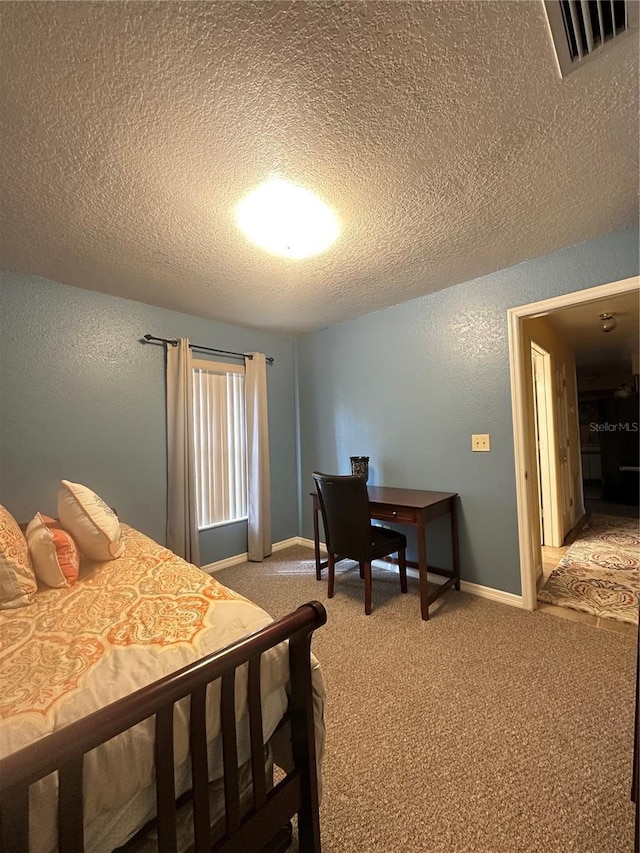 bedroom featuring light colored carpet, visible vents, a textured wall, a textured ceiling, and baseboards