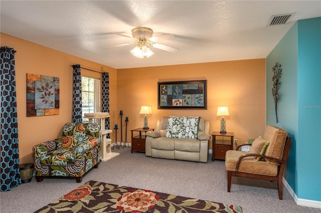 living area with a ceiling fan, baseboards, visible vents, and carpet flooring