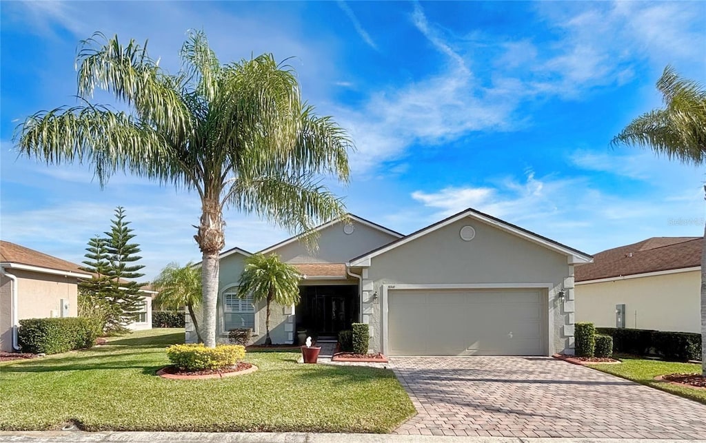 ranch-style house featuring a garage and a front yard