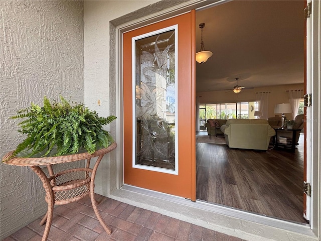 doorway to property with ceiling fan