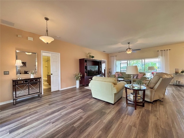 living room featuring dark wood-type flooring and ceiling fan