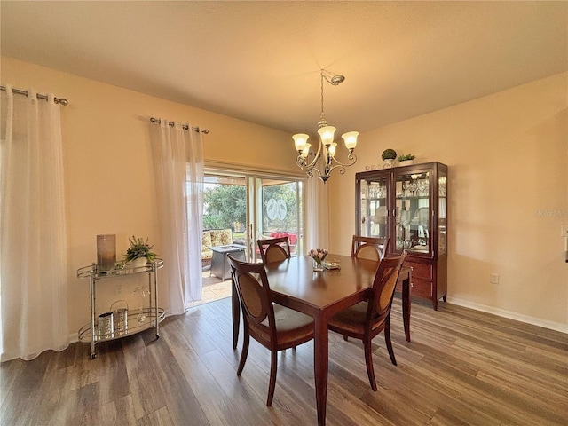 dining room featuring dark hardwood / wood-style floors and a chandelier