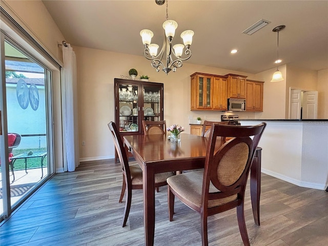 dining space featuring a chandelier and dark hardwood / wood-style flooring