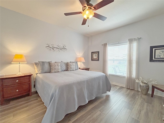 bedroom featuring ceiling fan and light hardwood / wood-style flooring