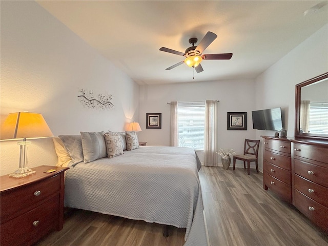 bedroom with dark hardwood / wood-style floors and ceiling fan