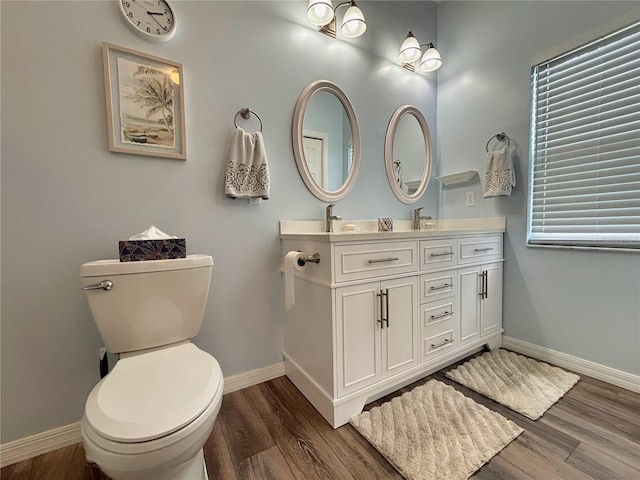 bathroom with vanity, hardwood / wood-style floors, and toilet