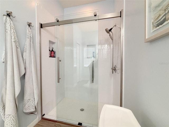 bathroom featuring a shower with door