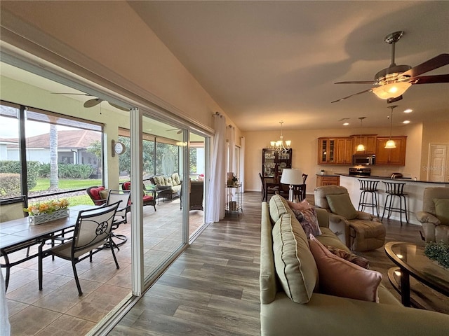 living room featuring hardwood / wood-style floors and ceiling fan with notable chandelier