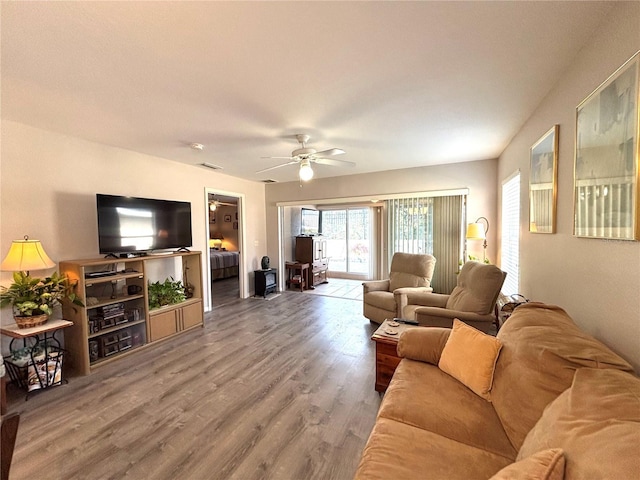 living room featuring hardwood / wood-style flooring and ceiling fan