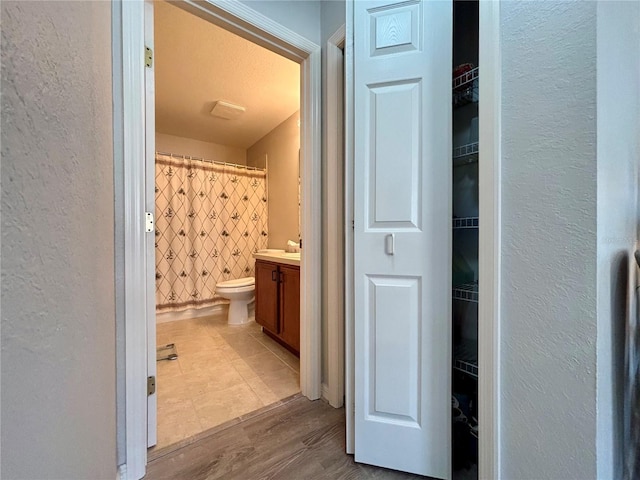 bathroom featuring vanity, hardwood / wood-style floors, and toilet