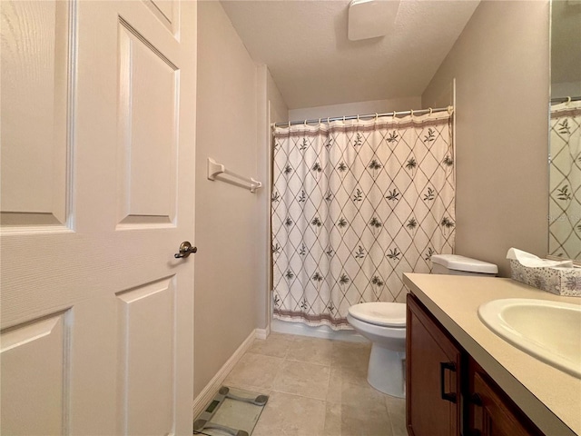 bathroom featuring tile patterned flooring, vanity, and toilet